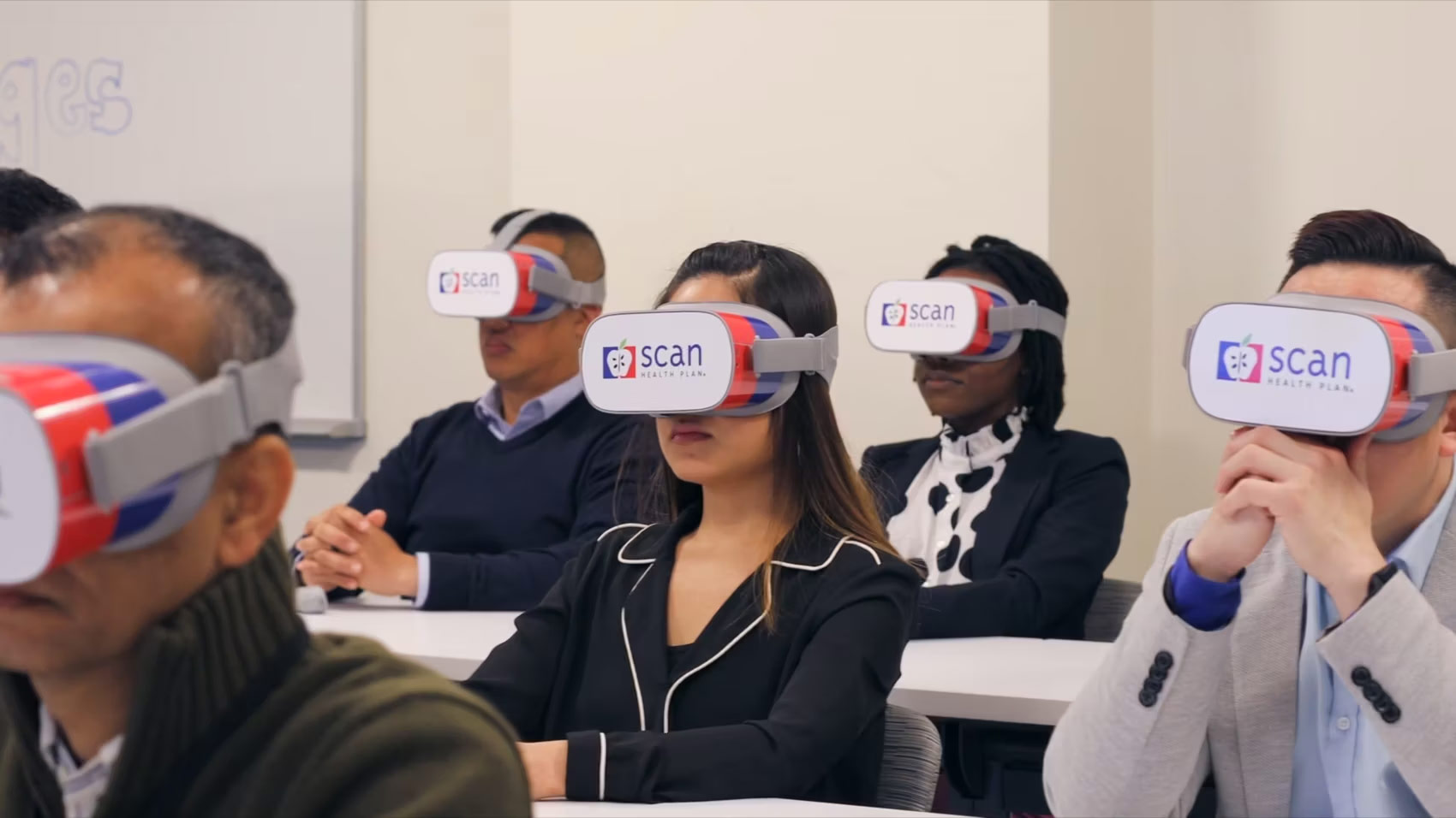 Participants wearing SCAN Trading Ages VR branded virtual reality headsets