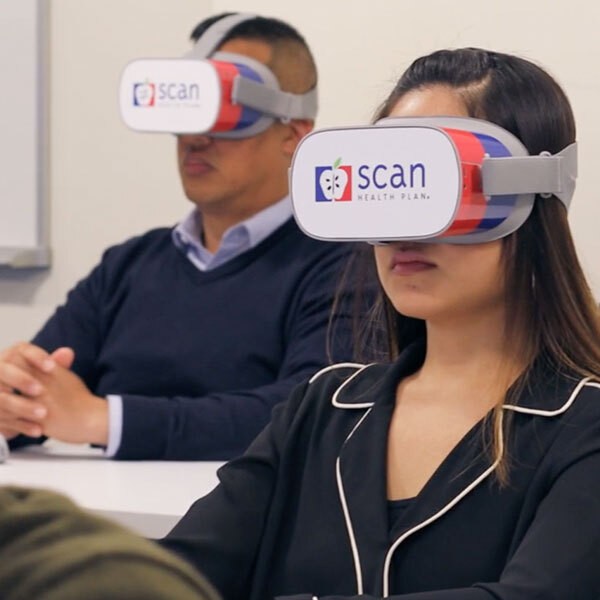 People wearing virtual reality goggles.